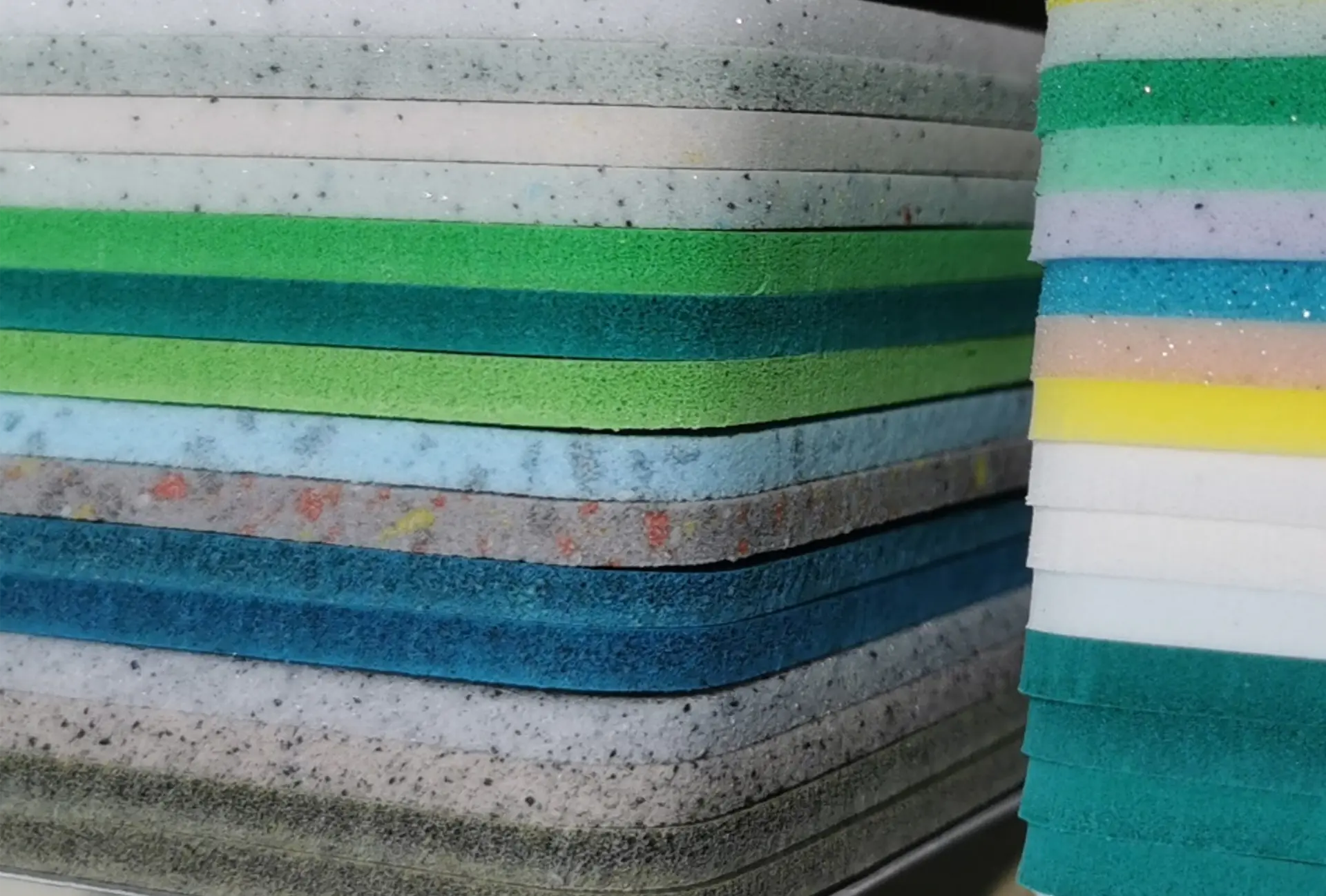 Rolling — stacked sheets of technical foam in multiple colours, densities and thicknesses
