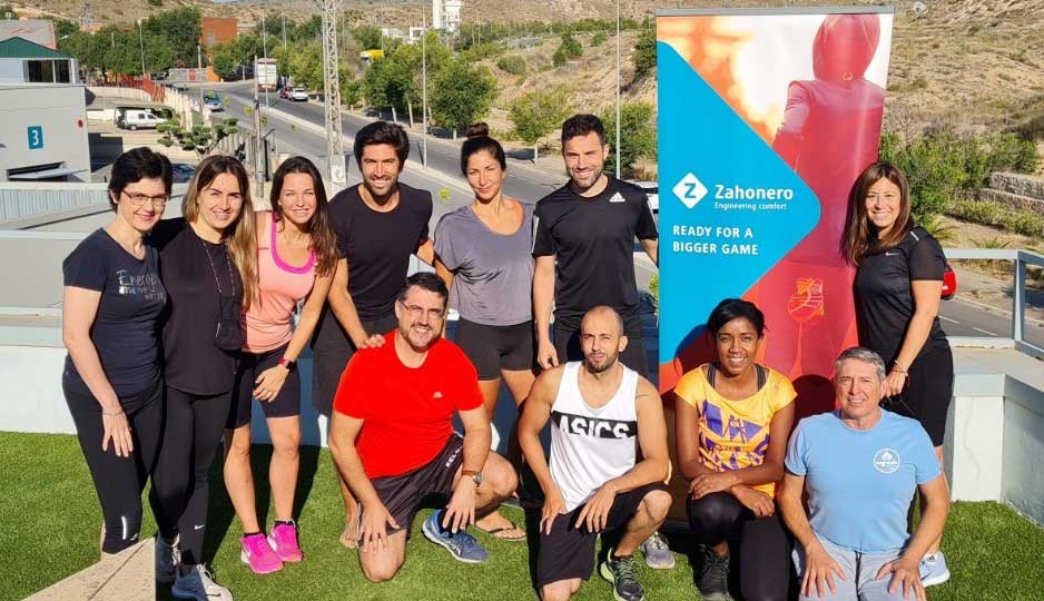 Zahonero team in front of a Ready for a bigger game banner